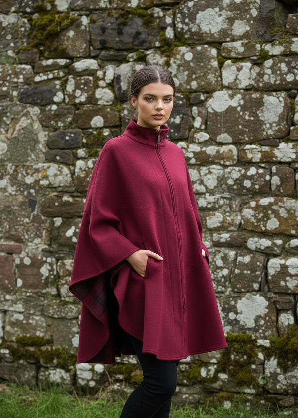 Woman wearing a Jimmy Hourihan burgundy coat on a white background