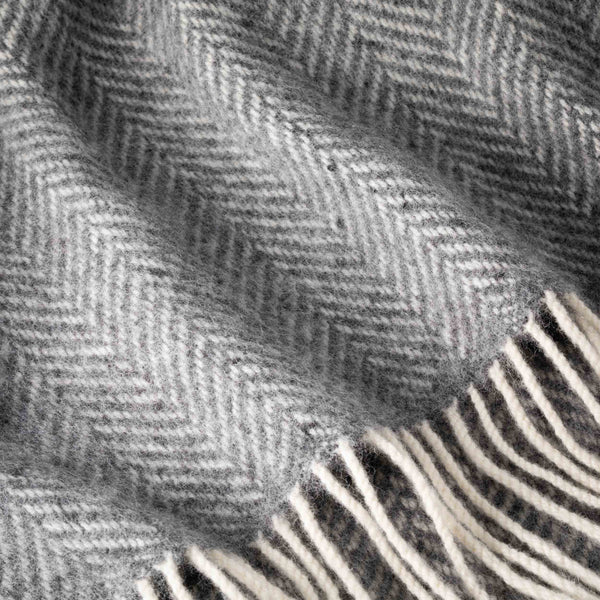 Close-up of a textured fabric with a herringbone pattern