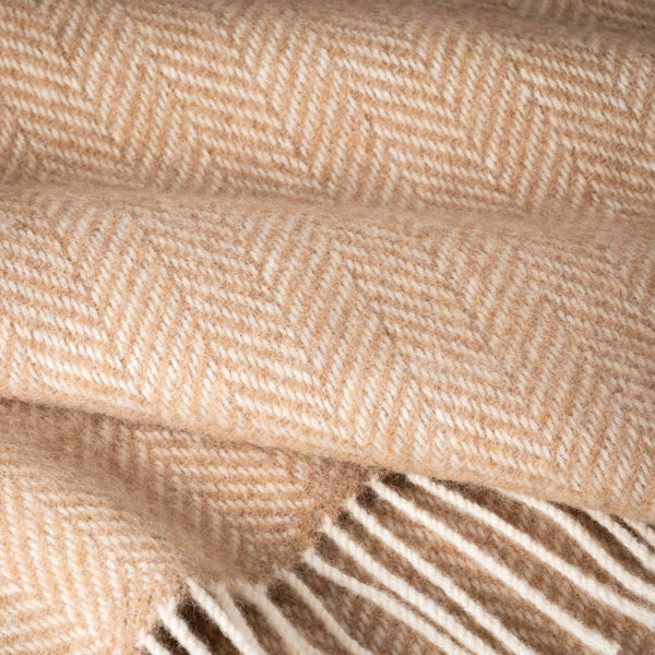 Close-up of beige fabric with a herringbone pattern