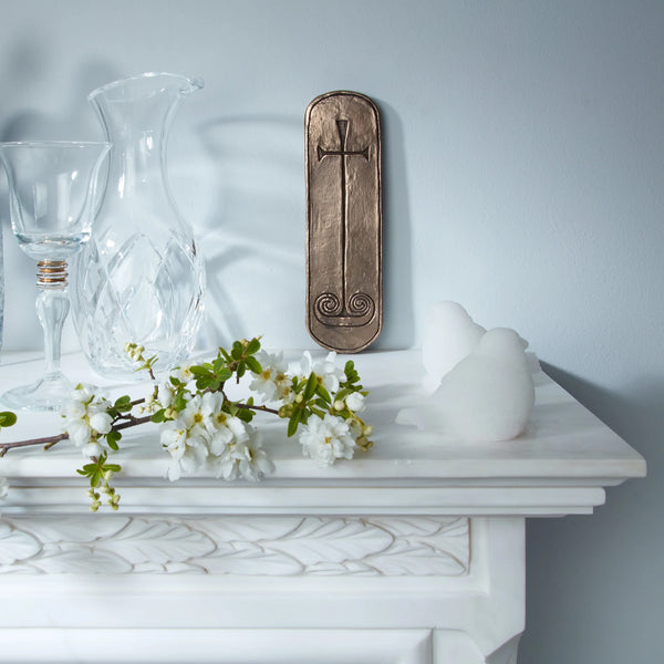Decorative items including a vase, wine glass, and flowers on a white surface with a gray background.