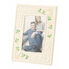 White photo frame with decorative leaves holding a picture of a couple.