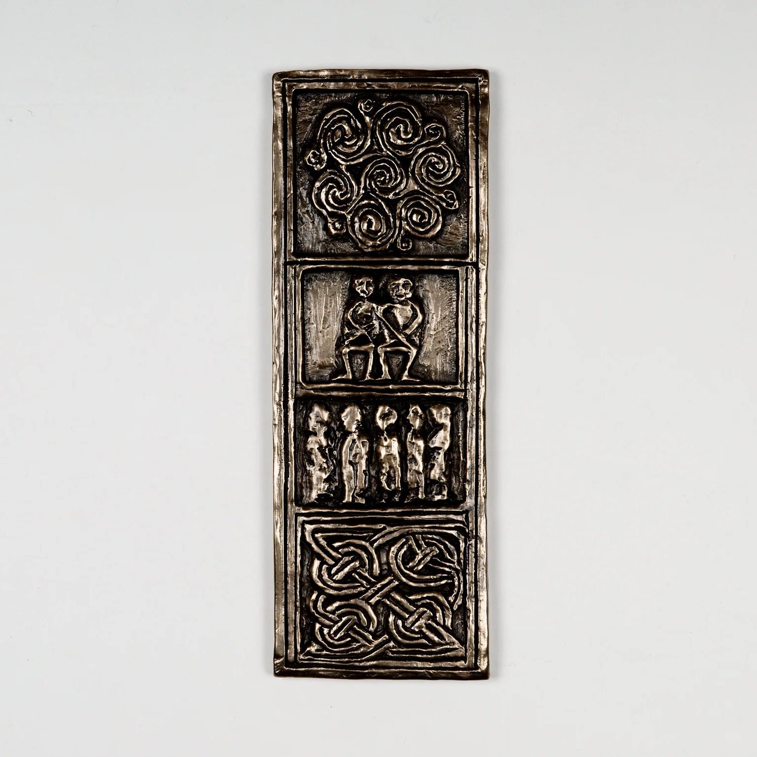 Decorative metal panel with intricate designs on a white background