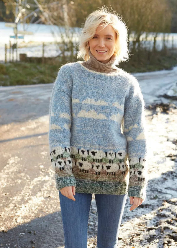 Person wearing a knitted sweater with sheep pattern outdoors