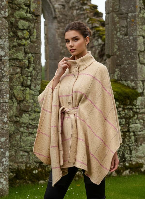Woman wearing a Jimmy Hourihan beige and pink plaid poncho on a white background