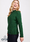 Woman wearing a green sweater with 'Aran Woollen Mills' logo on a white background