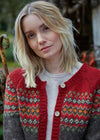 Woman wearing a red and gray patterned cardigan outdoors