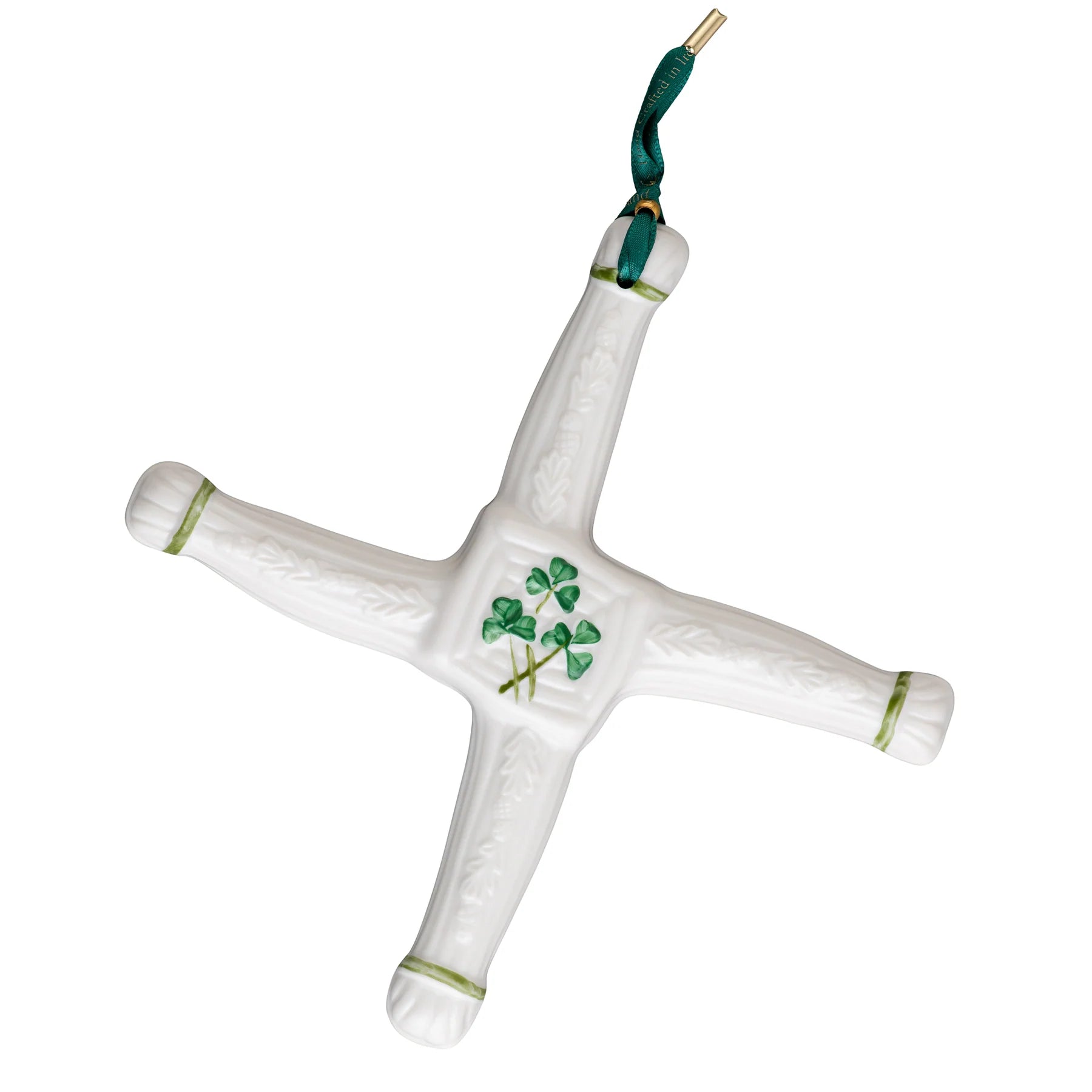 White ceramic cross with green accents and clover design on a white background