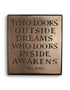 Who looks outside dreams…