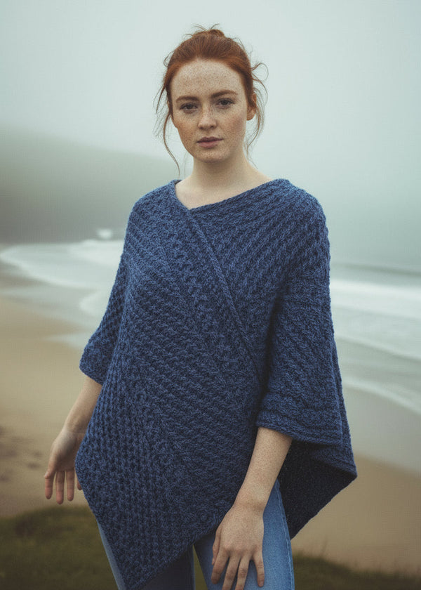 women wearing a blue aran knitted poncho
