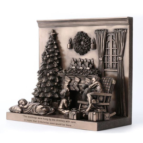 Decorative plaque with a Christmas scene, including a tree, stockings, and a fireplace.