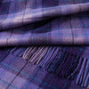 Close-up of a purple plaid fabric with fringes