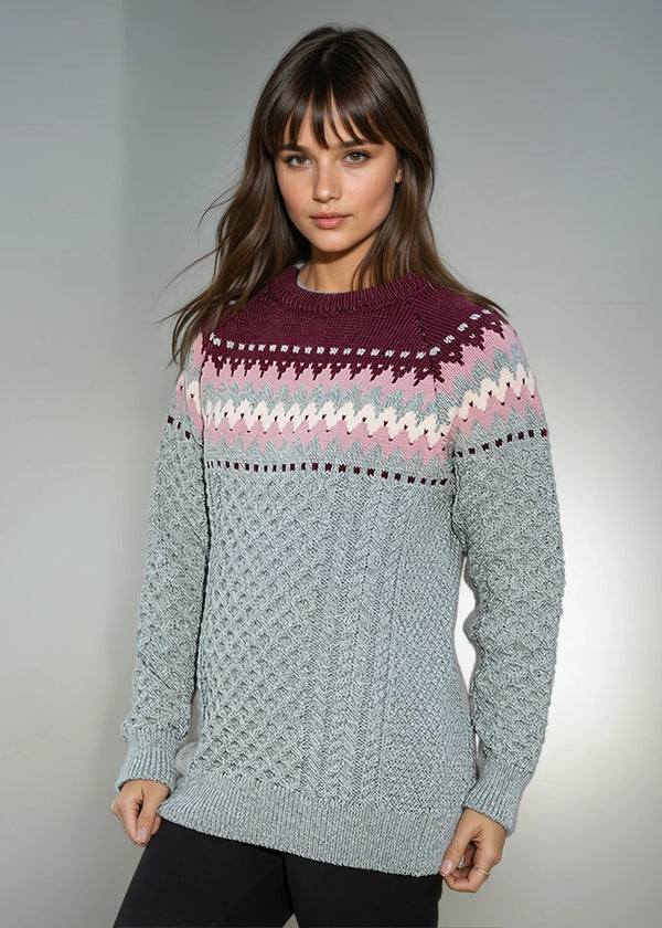 Woman wearing a Ladies Slim-Fit Aran Fairisle Sweater Aqua with a gray background