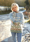 Woman wearing a sheep patterned sweater outdoors on a snowy day