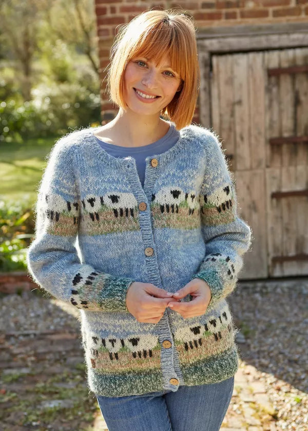 Woman wearing a knitted cardigan with sheep pattern outdoors