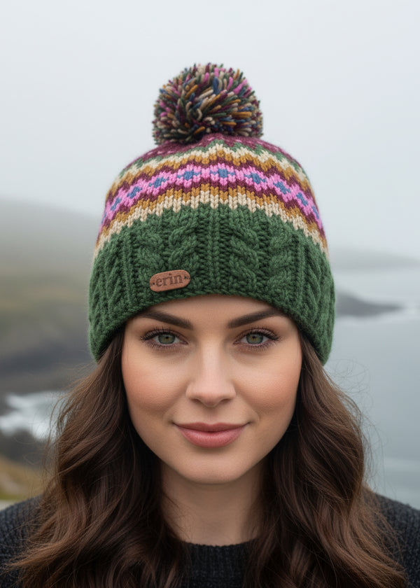 Knitted erin knitwear beanie with colorful pattern and pom-pom on a white background