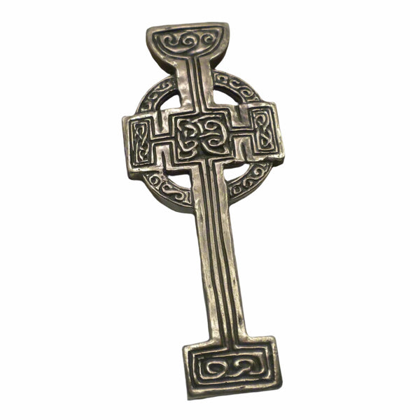 Decorative silver cross on a light gray background