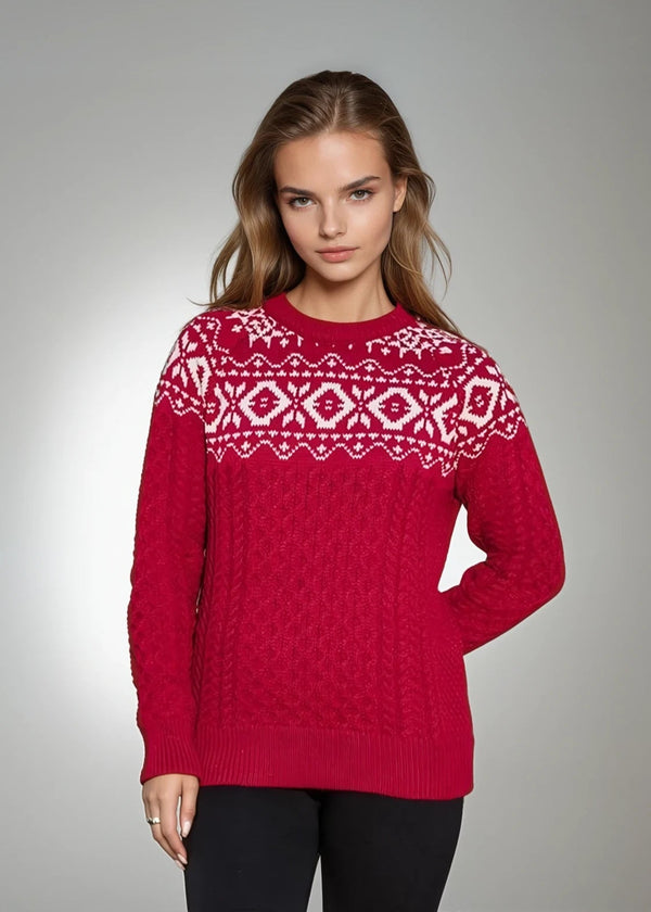 Woman wearing a red jacquard aran sweater with white patterns on a gray background