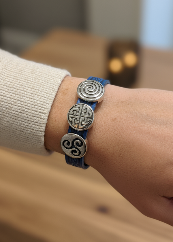 Bracelet with Celtic knot designs on a wrist.