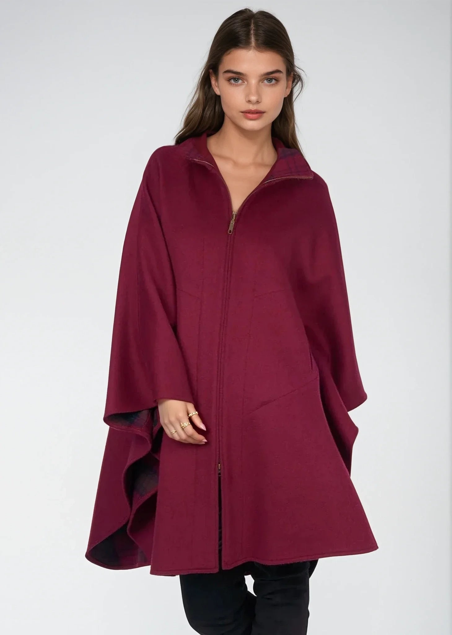 Woman wearing a Jimmy Hourihan burgundy coat on a white background