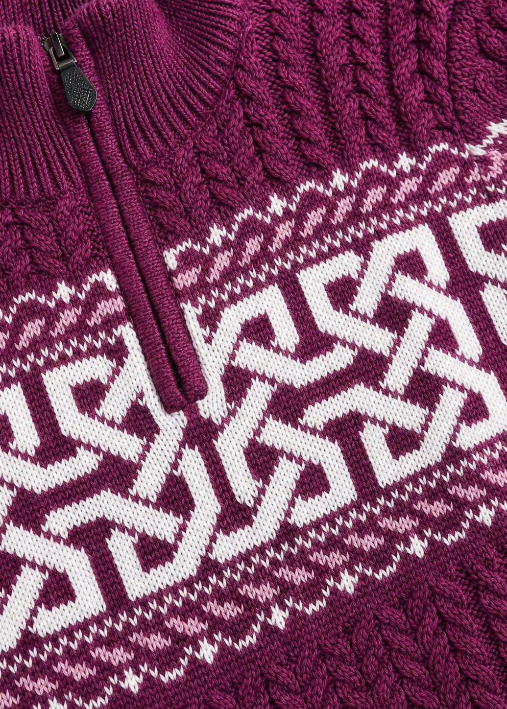 Close-up of a maroon knit sweater with white pattern