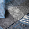 Close-up of a textured fabric with blue, gray, and white pattern