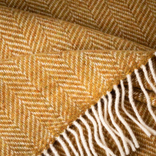 Close-up of a textured fabric with a herringbone pattern in brown and white.
