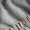 Close-up of a textured fabric with a herringbone pattern