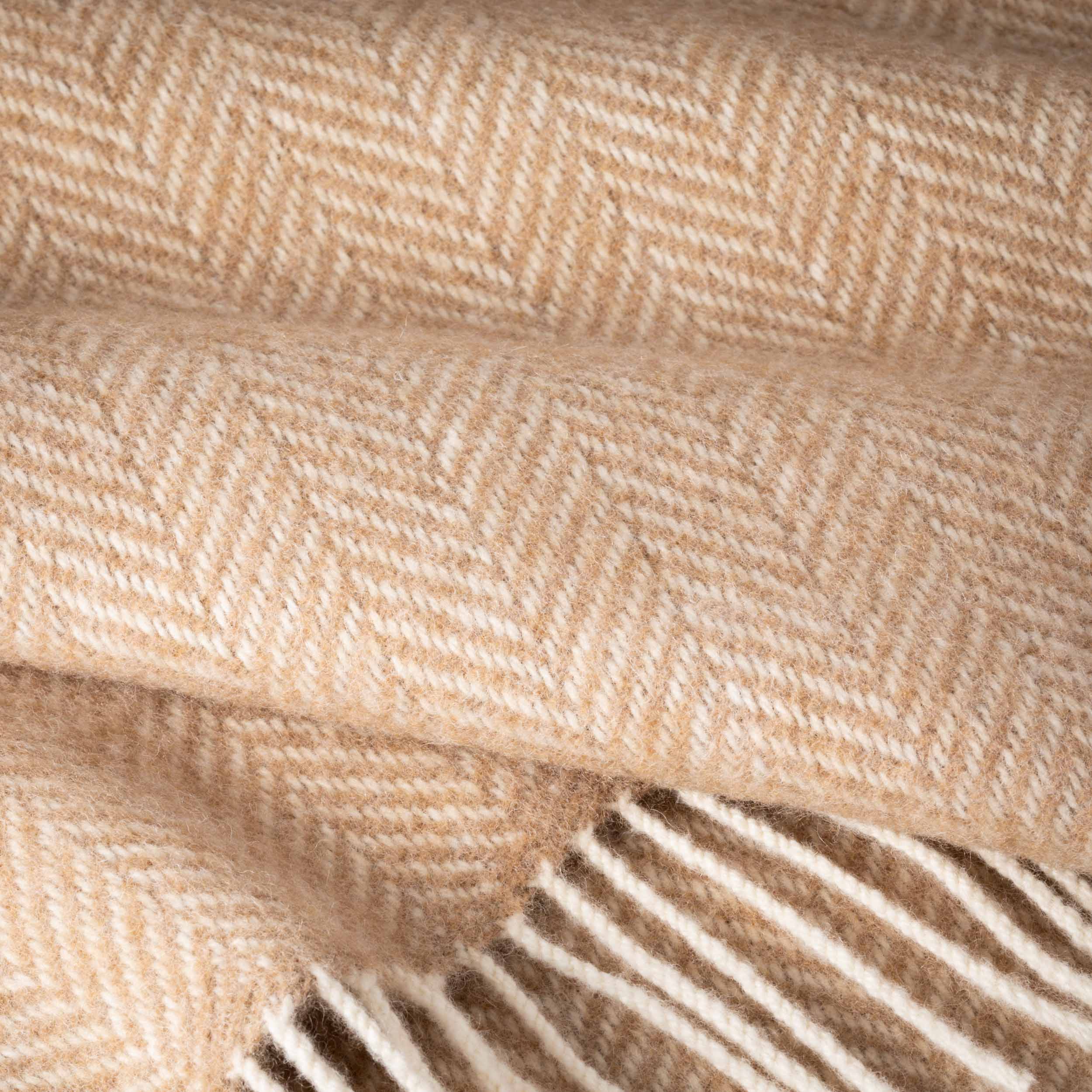 Close-up of beige fabric with a herringbone pattern