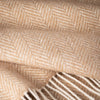Close-up of beige fabric with a herringbone pattern
