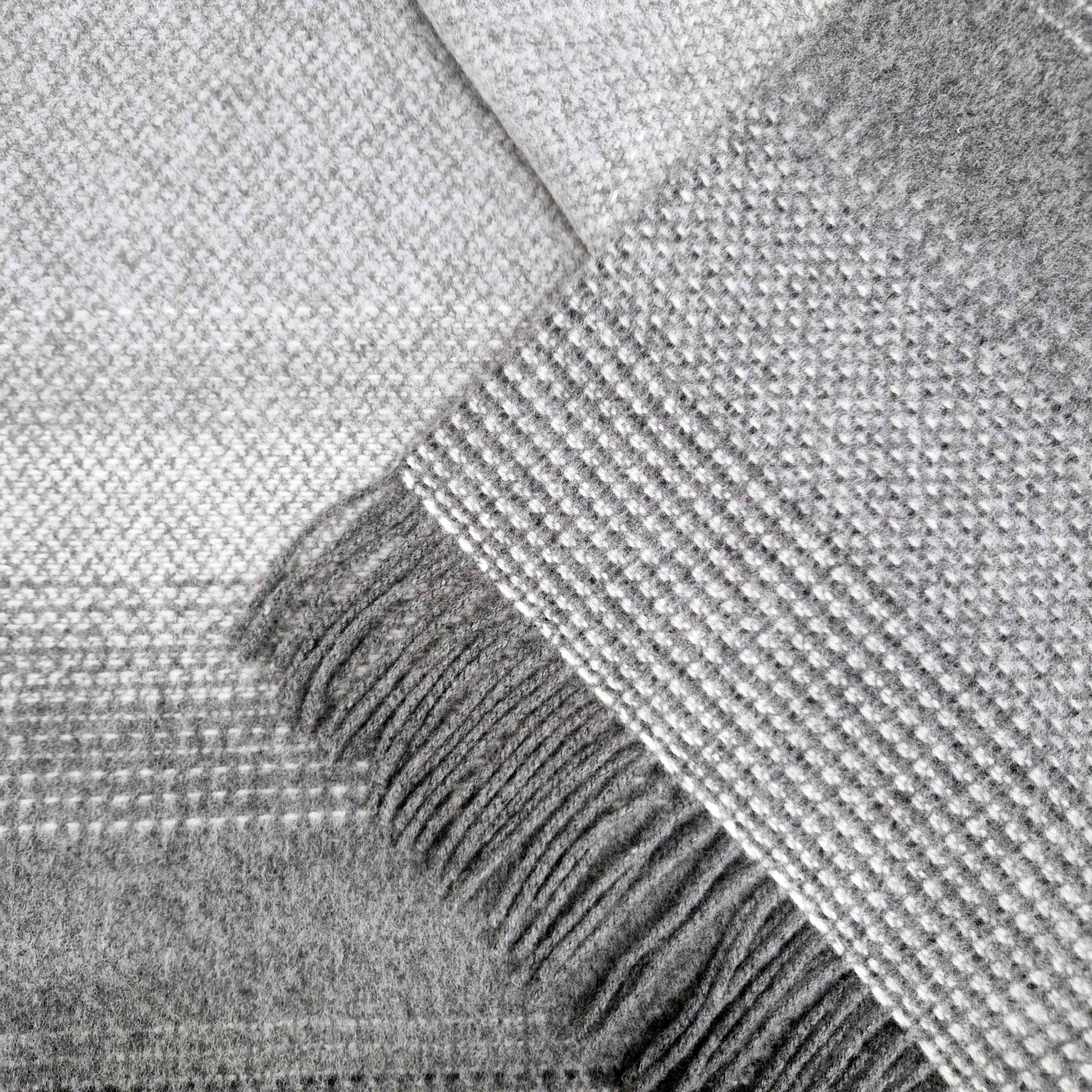 Close-up of a textured gray fabric with fringes