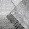 Close-up of a textured gray fabric with fringes