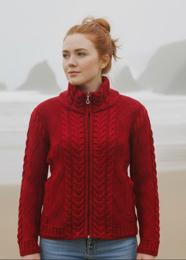 Woman wearing a red knitted jacket with a mountainous background