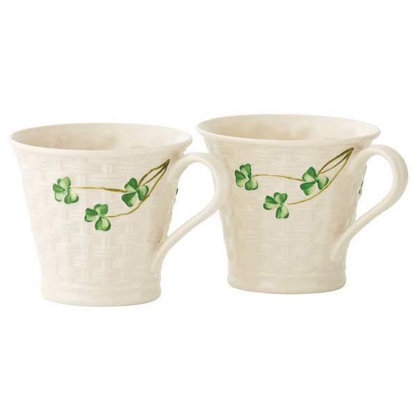Two ceramic mugs with clover leaf design on a white background
