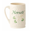 White mug with 'Herself' text and green leaf design on a white background