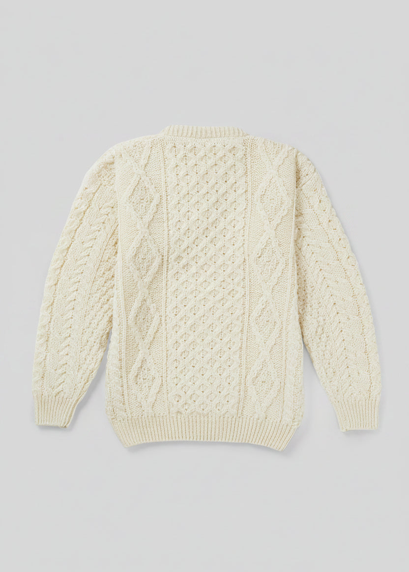 Cream-colored cable knit sweater on a light gray background