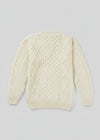 Cream-colored cable knit sweater on a light gray background