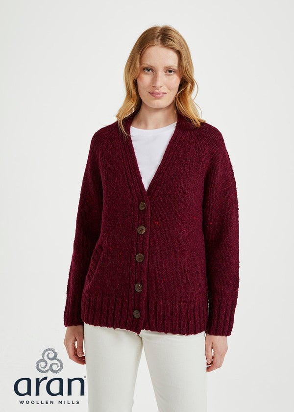 Woman wearing a burgundy cardigan over a white shirt on a white background, with Aran Woollen Mills logo.