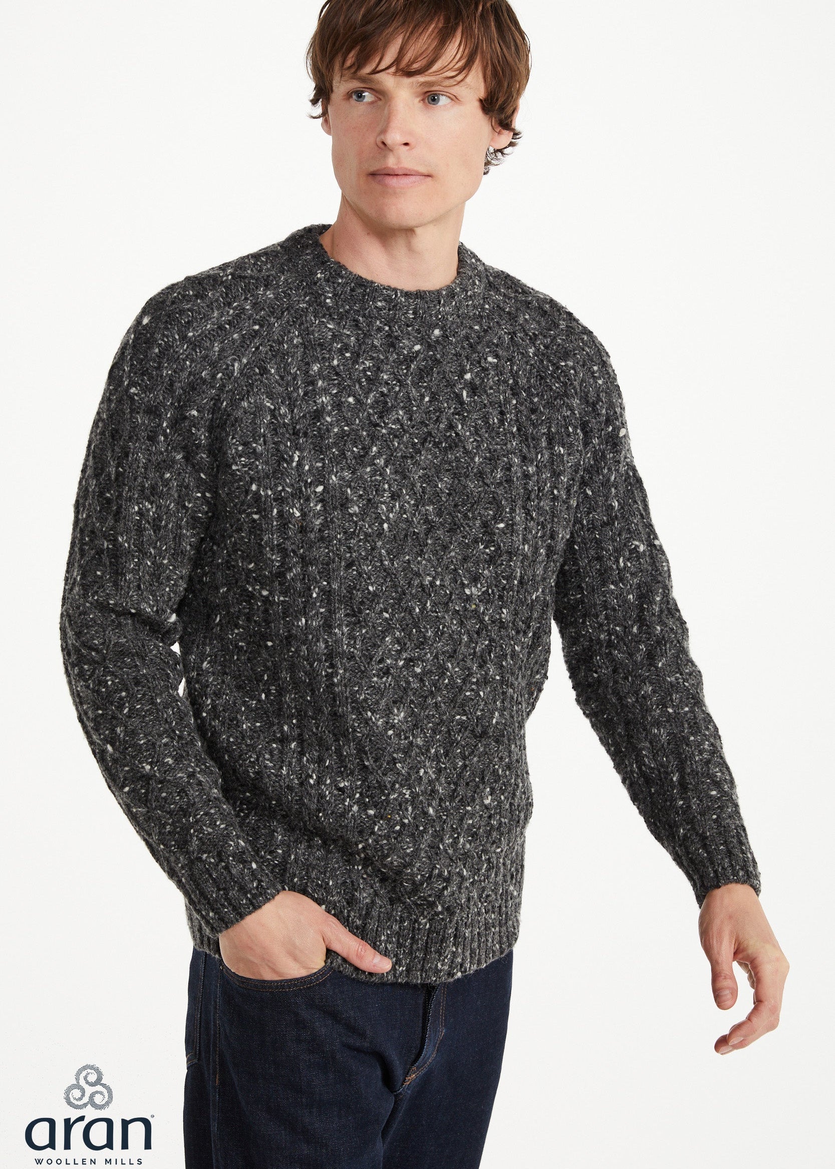 Man wearing a gray speckled sweater on a white background