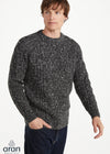 Man wearing a gray speckled sweater on a white background
