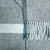Close-up of a blue and gray plaid fabric with fringed edge