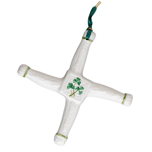 White ceramic cross with green accents and clover design on a white background