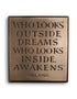 Who looks outside dreams…