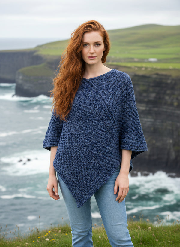 women wearing a blue aran knitted poncho 