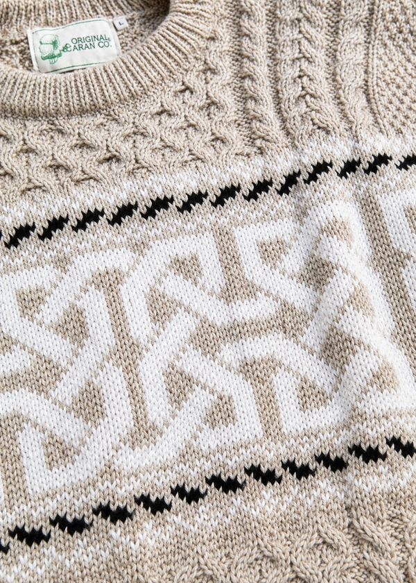 Close-up of a knitted sweater with a pattern and 'Original Design Co' label.