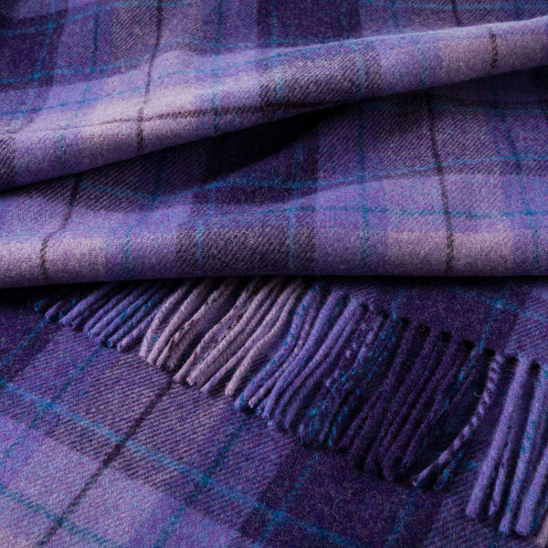 Close-up of a purple plaid fabric with fringes