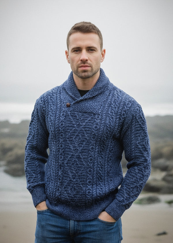 Man wearing a blue knitted aran shawl sweater denim color