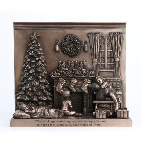 Decorative wall plaque with Christmas scene, including a tree, fireplace, and stockings.