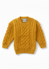 Mustard yellow cable knit sweater on a white background