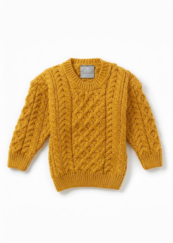 Mustard yellow cable knit sweater on a white background