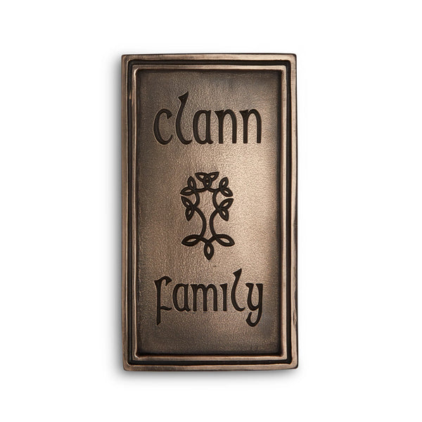 Bronze plaque with 'clann family' engraving on a white background